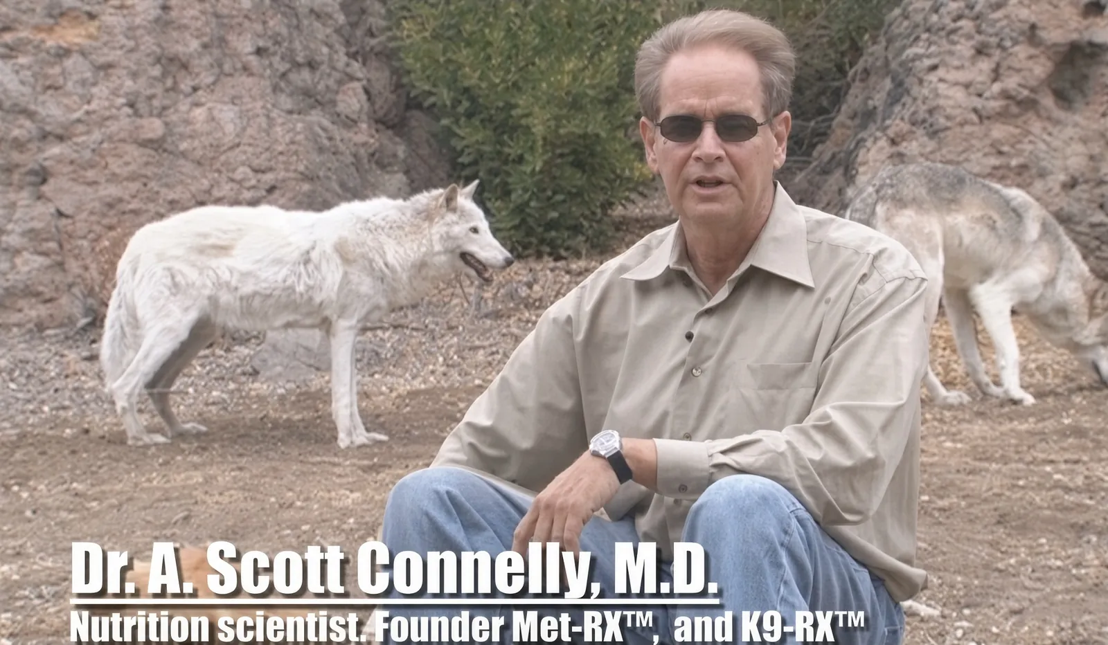 Dr. A. Scott Connelly in an early K9-Rx video, seated outdoors with wolves behind him